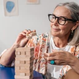 Senior woman working on a puzzle at home.