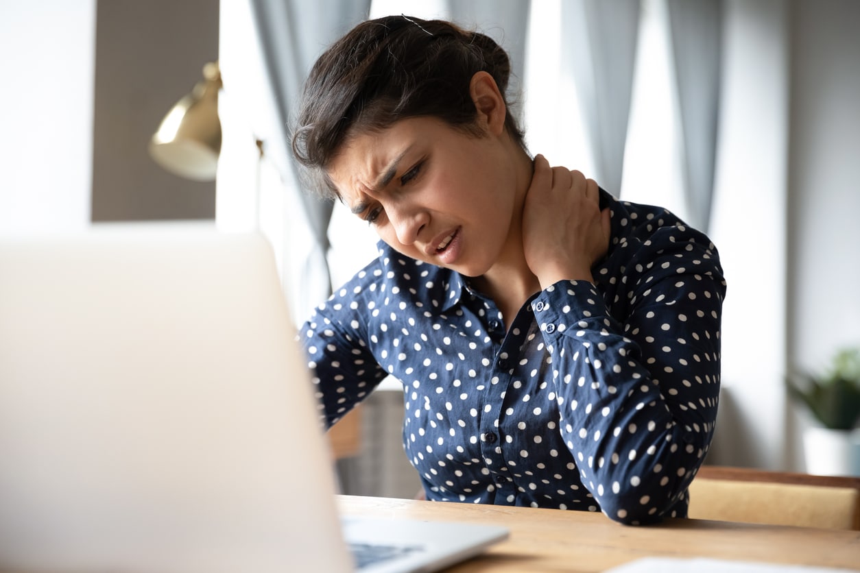 Woman holding neck experiencing Fibromyalgia pain
