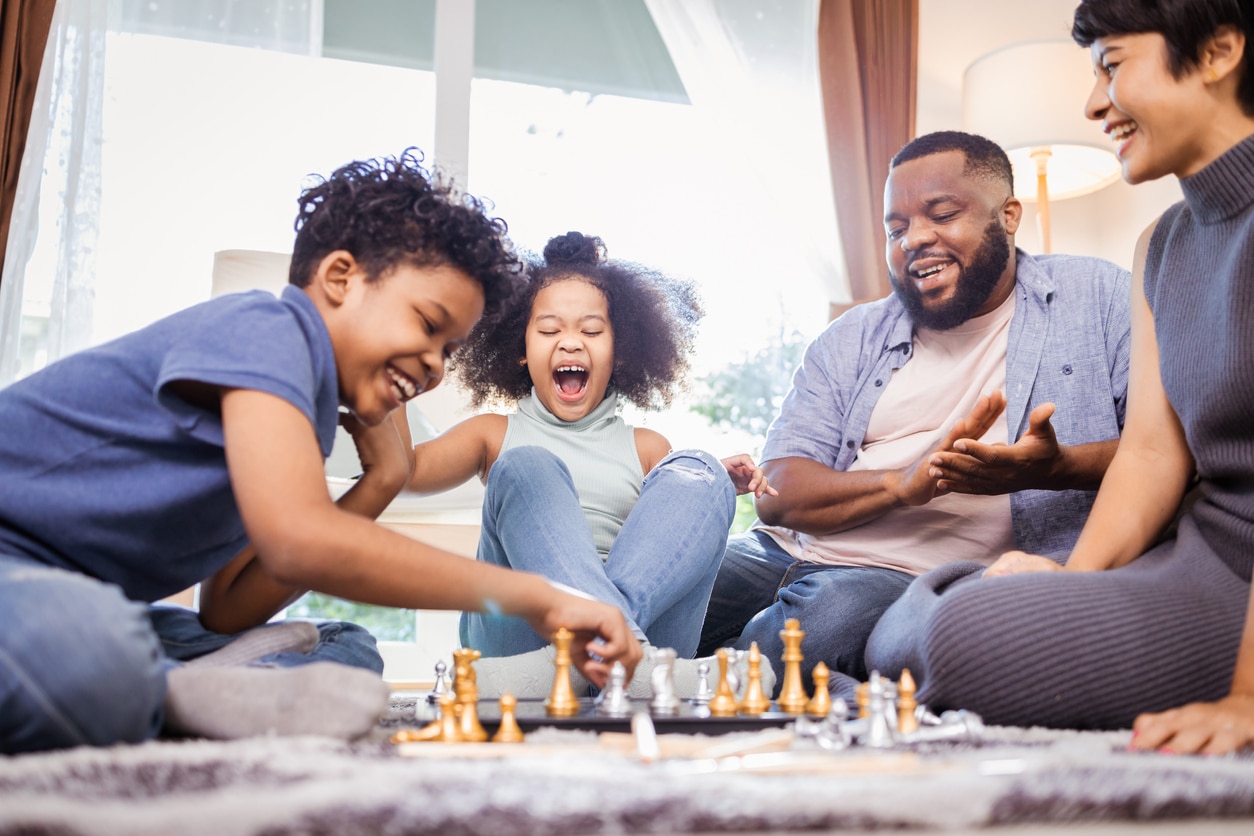 Family game night playing chess.