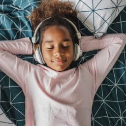 Young girl wears over ear headphones
