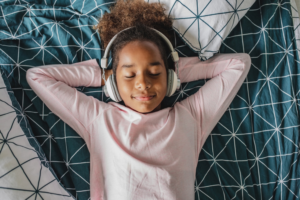 Young girl wears over ear headphones