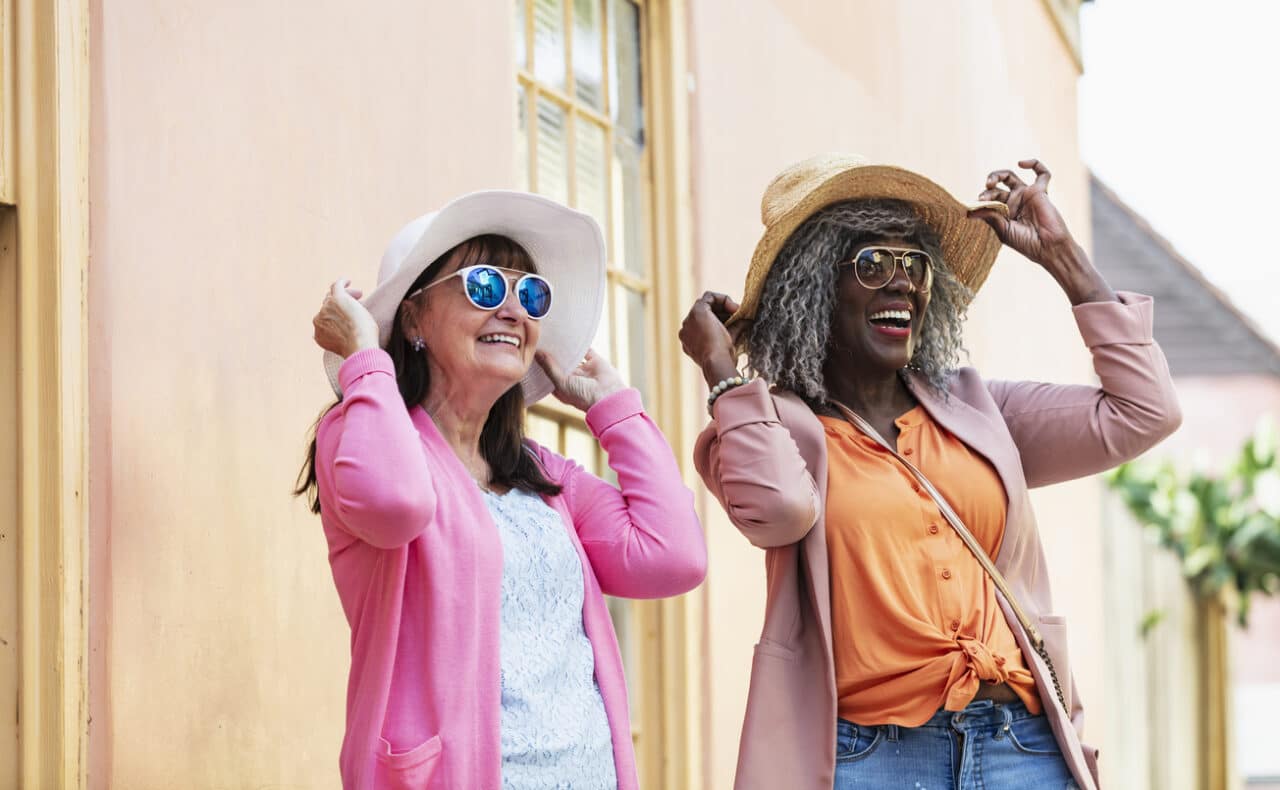 Two senior women wearing cute outfits.